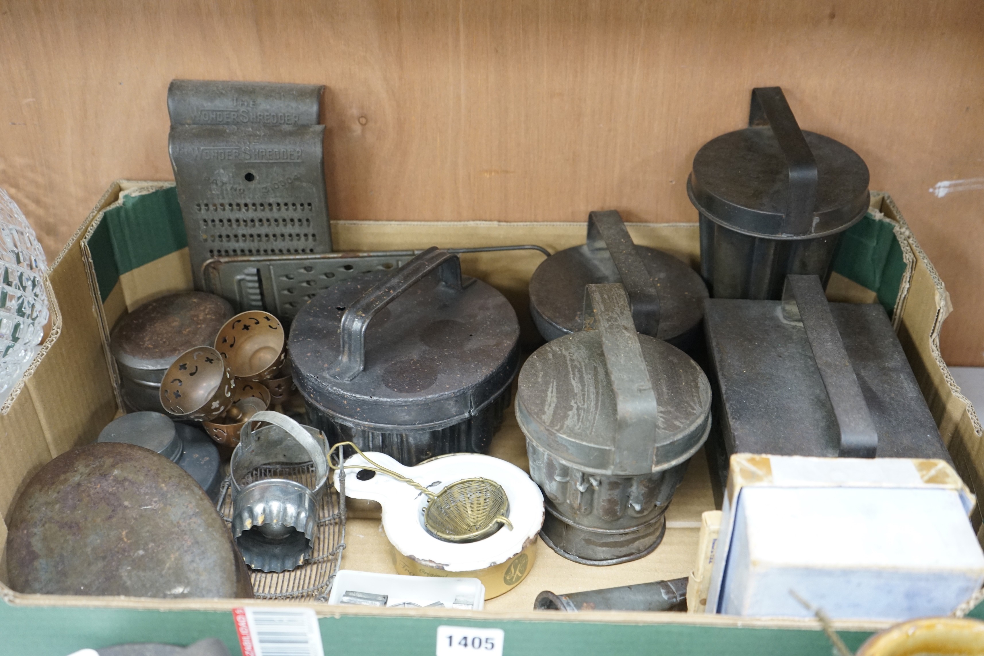 A good collection of tin plated iron jelly moulds, pastry moulds and kitchenalia